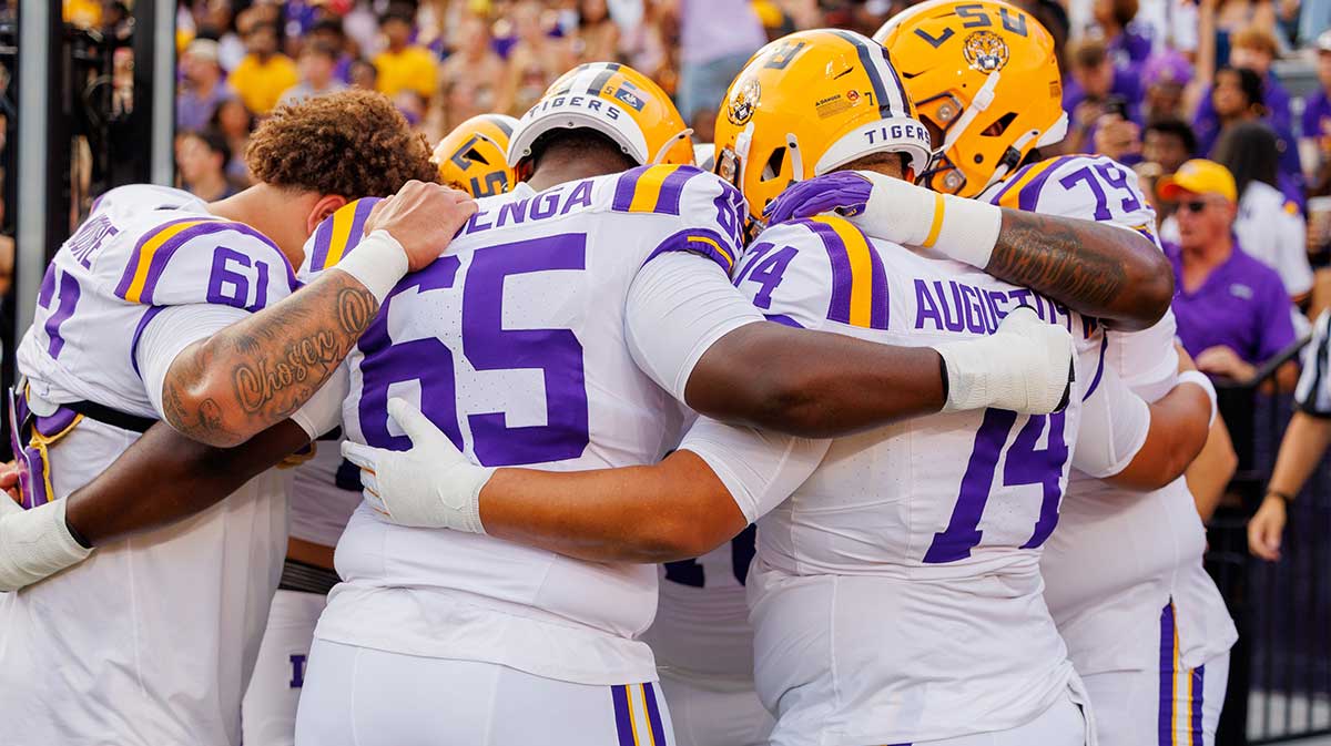 LSU Tigers offensive lineman Paul Mubenga (65) huddles with offensive lineman Braelin Moore (61) and offensive lineman Braden Augustus (74) during warmups before the game against the Southeastern Louisiana Lions at Tiger Stadium.