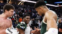 Timberwolves guard Anthony Edwards (5) and Milwaukee Bucks forward Giannis Antetokounmpo (34) shake hands after the game at Target Center