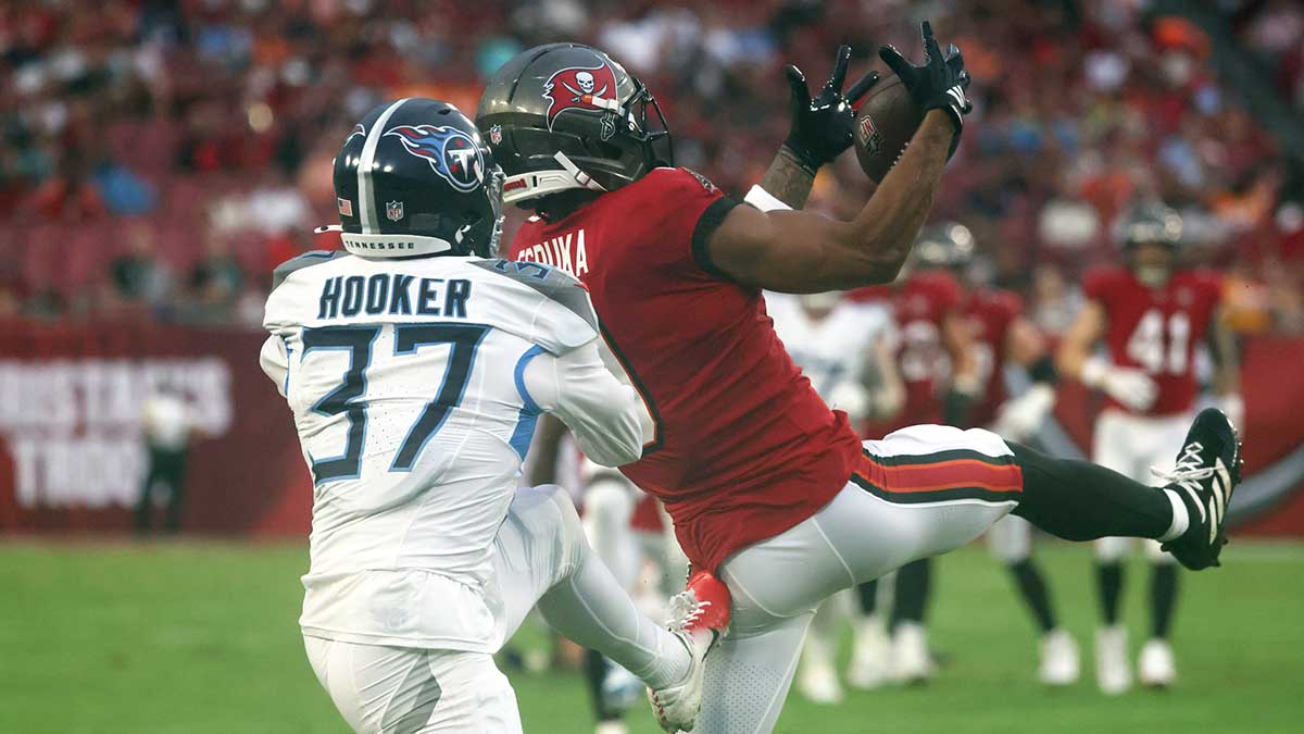 Tampa Bay Buccaneers wide receiver Emeka Egbuka (9) catches the ball over Tennessee Titans safety Amani Hooker (37) during the first quarter at Raymond James Stadium.