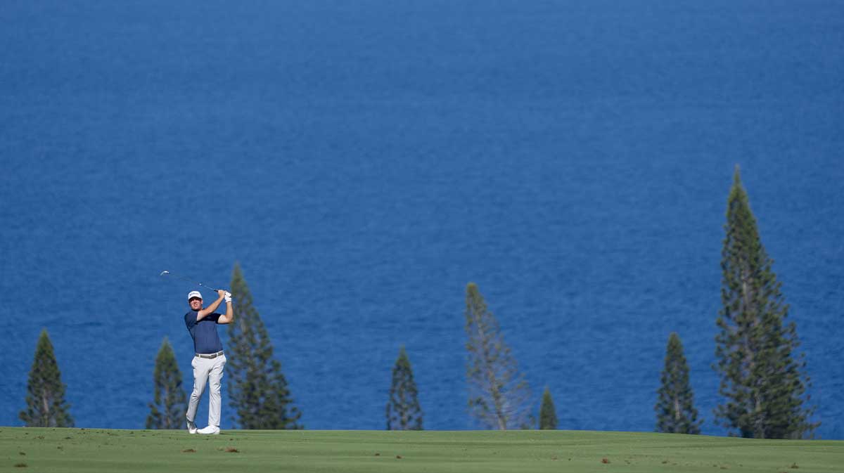 Tom Hoge hits his fairway shot on the fourth hole during the final round of The Sentry golf tournament at Plantation Course at Kapalua.