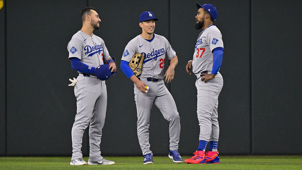 Los Angeles Dodgers left fielder Michael Conforto (23) and center fielder Tommy Edman (25) and right fielder Teoscar Hernandez (37) during the game between the Texas Rangers and the Los Angeles Dodgers at Globe Life Field.