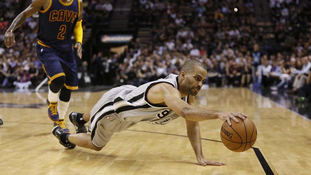 San Antonio Spurs point guard Tony Parker (9) dives to save a loose ball from going out of bounds against the Cleveland Cavaliers during the first half at AT&T Center.