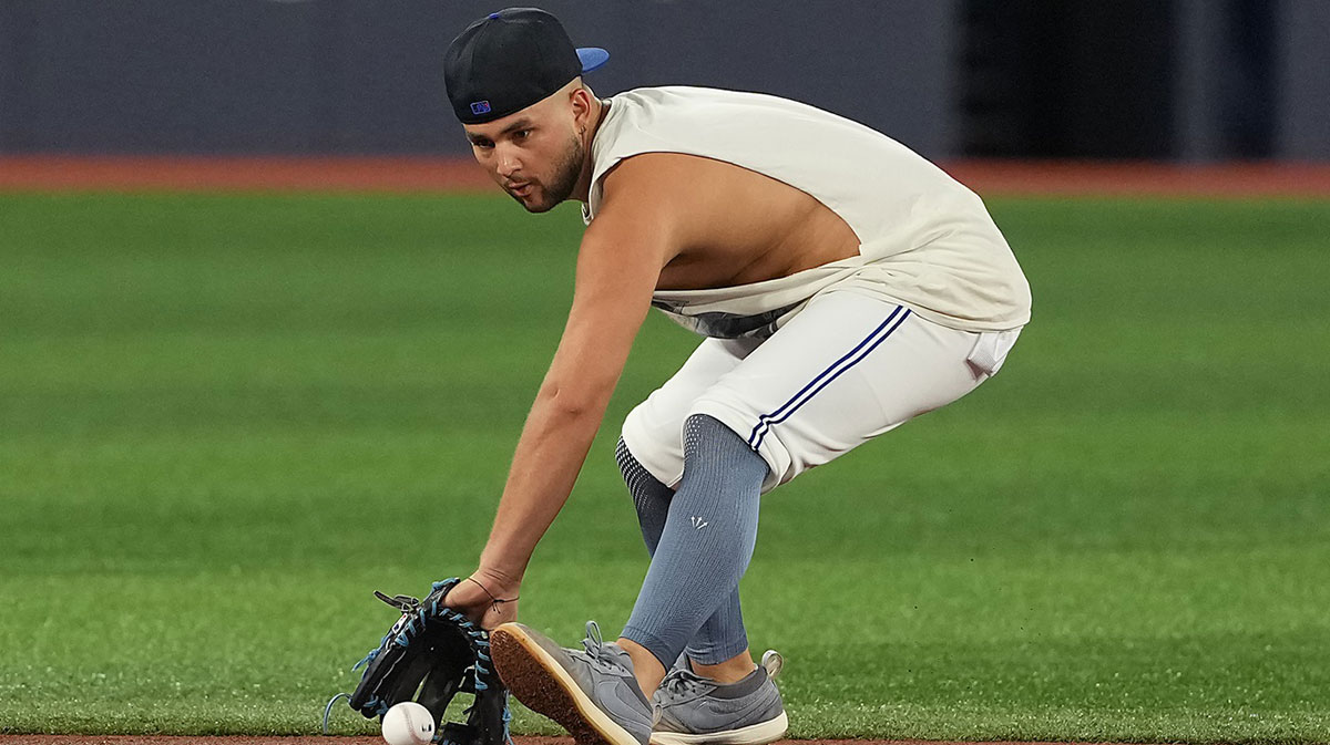 Toronto Blue Jays shortstop Bo Bichette (11) fields balls during batting practice before a game against the Texas Rangers at Rogers Centre.