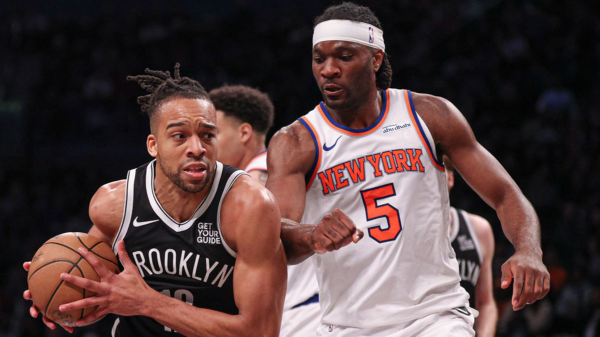 Apr 13, 2025; Brooklyn, New York, USA; Brooklyn Nets forward Tosan Evbuomwan (12) drives to the basket after the game New York Knicks forward Precious Achiuwa (5) during the second half at Barclays Center. Mandatory Credit: Vincent Carchietta-Imagn Images