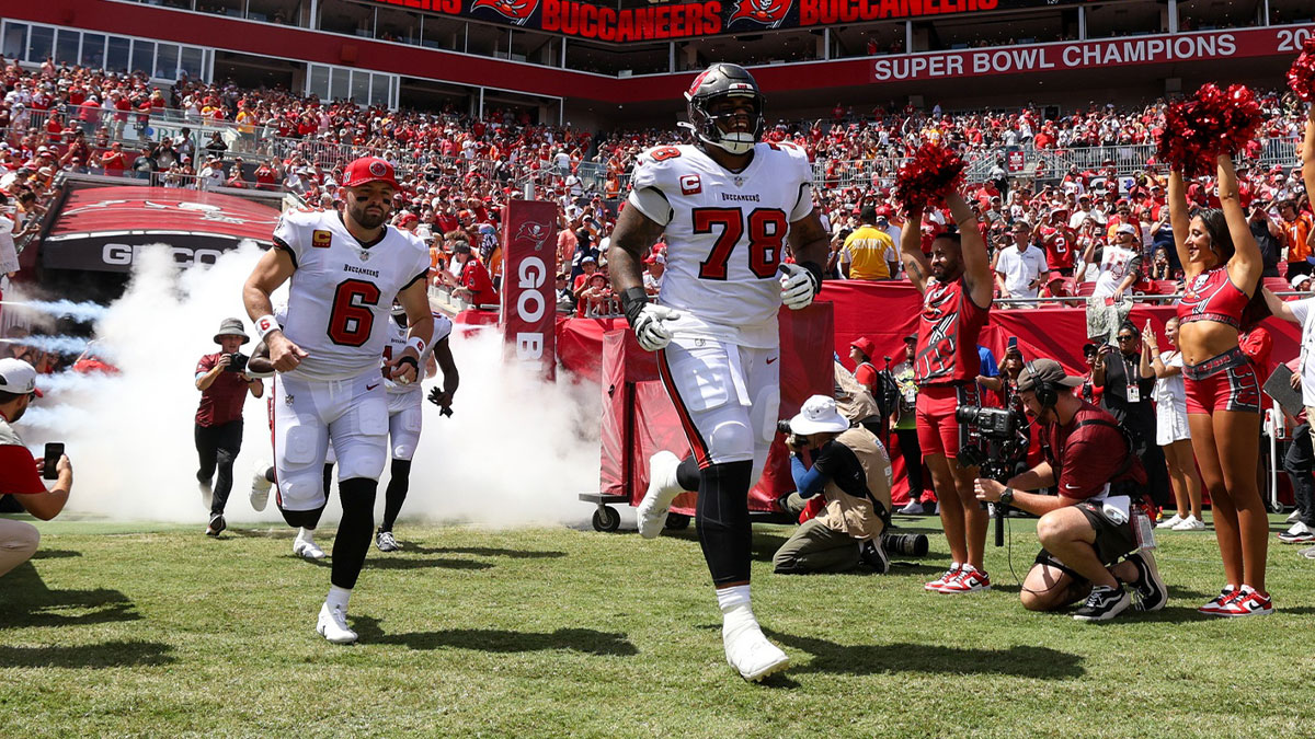 Tampa Bay Buccaneers quarterback Baker Mayfield (6) and offensive tackle Tristan Wirfs (78) take the field for a game against the Denver Broncos at Raymond James Stadium.