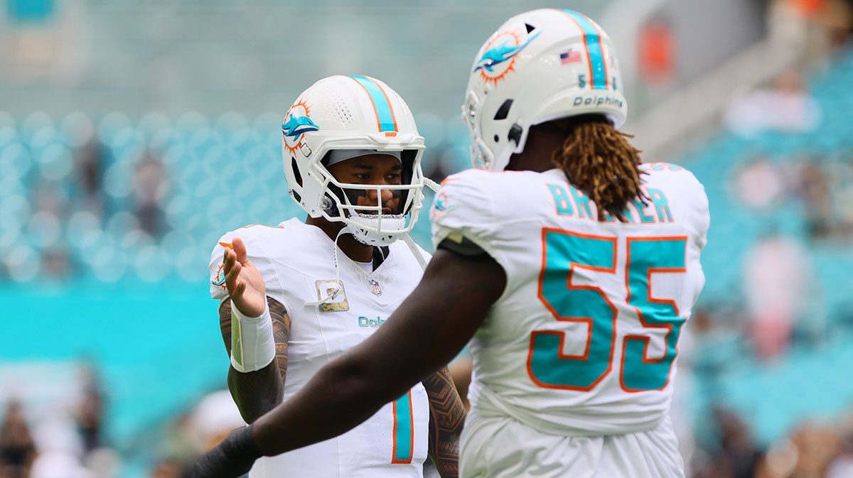 Miami Dolphins quarterback Tua Tagovailoa (1) and guard Aaron Brewer (55) shake hands before the game against the Las Vegas Raiders at Hard Rock Stadium.