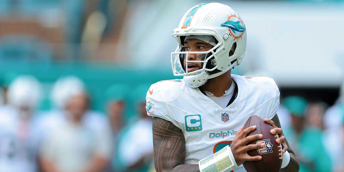 Miami Dolphins quarterback Tua Tagovailoa (1) looks for a passing option against the New England Patriots during the first quarter at Hard Rock Stadium.