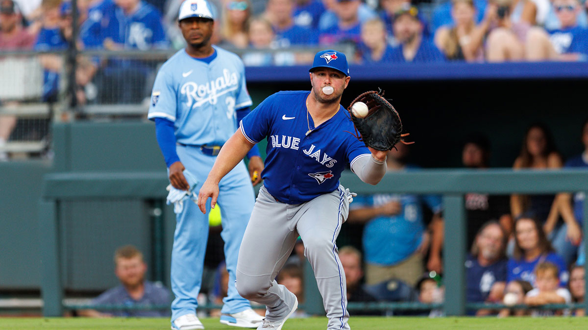 Toronto Blue Jays first base Ty France (2) reaches for a throw to first base during the second inning against the Kansas City Royals at Kauffman Stadium.