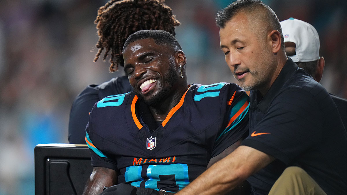 Miami Dolphins wide receiver Tyreek Hill (10) is tended to by medical staff after injuring his leg against the New York Jets during the second half at Hard Rock Stadium.