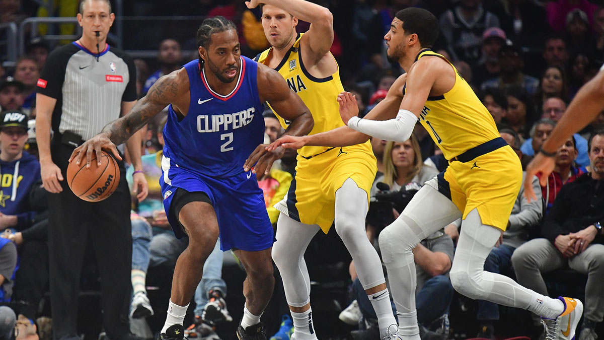 Los Angeles Clippers forward Kawhi Leonard (2) moves the ball against Indiana Pacers guard Tyrese Haliburton (0) during the first half at Crypto.com Arena.