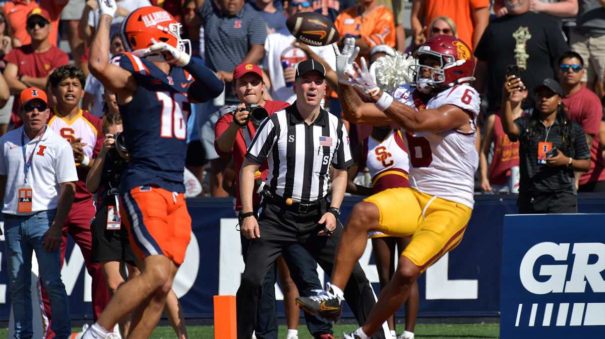 Southern California Trojans wide receiver Makai Lemon (6) scores a touchdown on a pass from quarterback Jayden Maiava (14) as Illinois Fighting Illini defensive back Tanner Heckel (16) defends during the second half at Memorial Stadium.