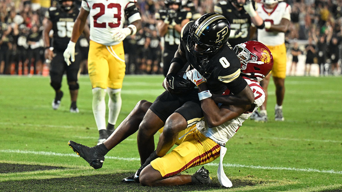 Purdue Boilermakers wide receiver Nitro Tuggle (0) catches a pass for a touchdown while being tackled by USC Trojans cornerback DeCarlos Nicholson (17) during the second half at Ross-Ade Stadium.