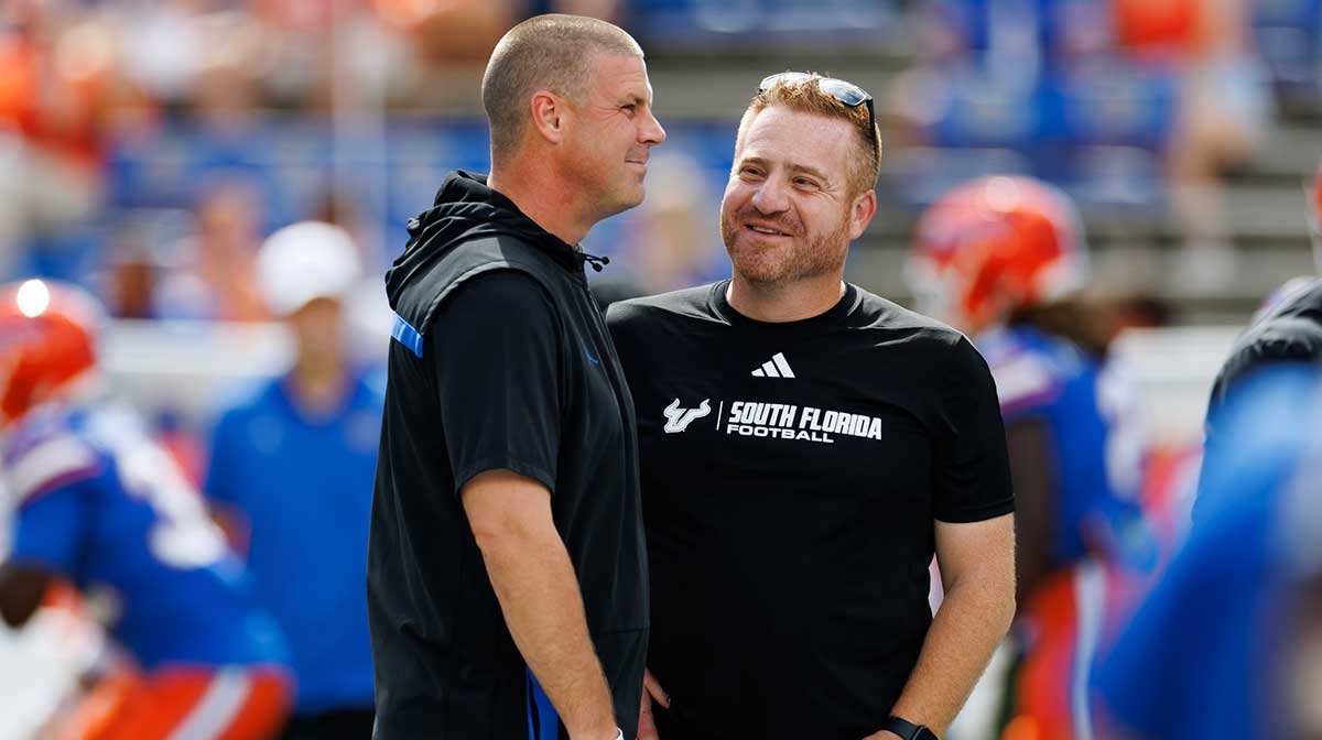 Florida Gators head coach Billy Napier and South Florida Bulls head coach Alex Golesh talk before the game at Ben Hill Griffin Stadium.
