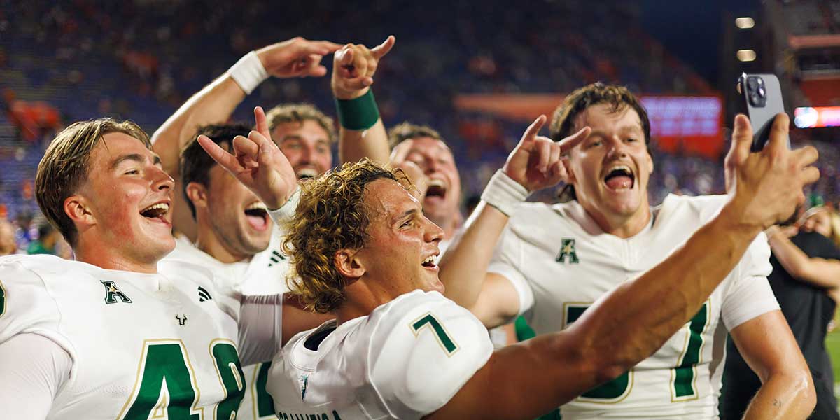 South Florida Bulls place kicker Nico Gramatica (7), South Florida Bulls long snapper Turner McLaughlin (48) and teammates celebrate after a game against the Florida Gators at Ben Hill Griffin Stadium.