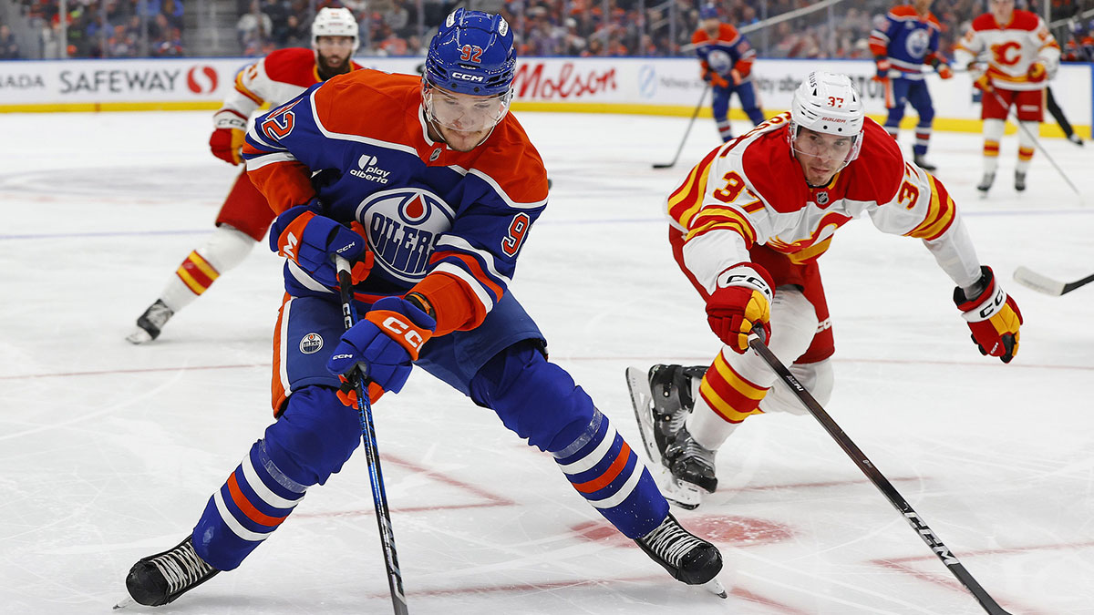Edmonton Oilers forward Vasily Podkolzin (92) protects the puck from Calgary Flames defensemen Yan Kuznetsov (37) during the first period at Rogers Place.