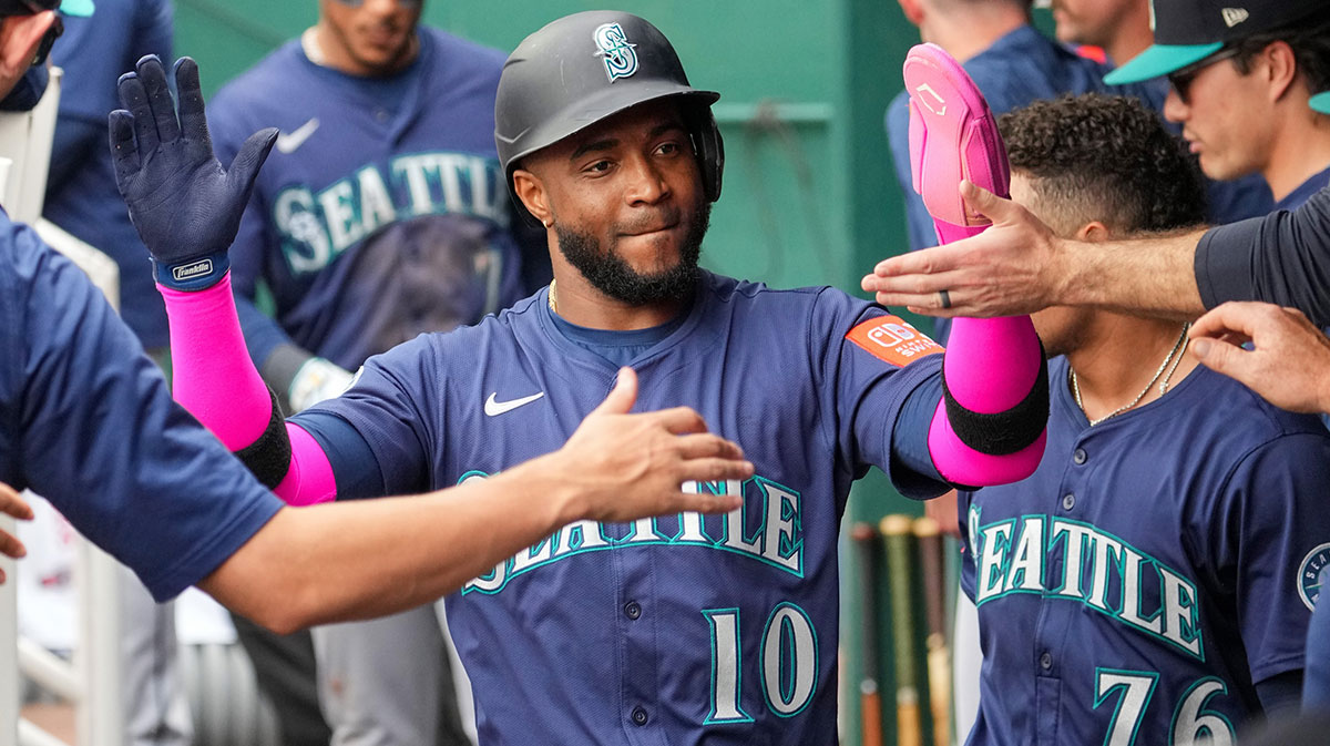 Seattle Mariners right fielder Victor Robles (10) is congratulated in the dugout against the Kansas City Royals after scoring during the eighth inning at Kauffman Stadium.
