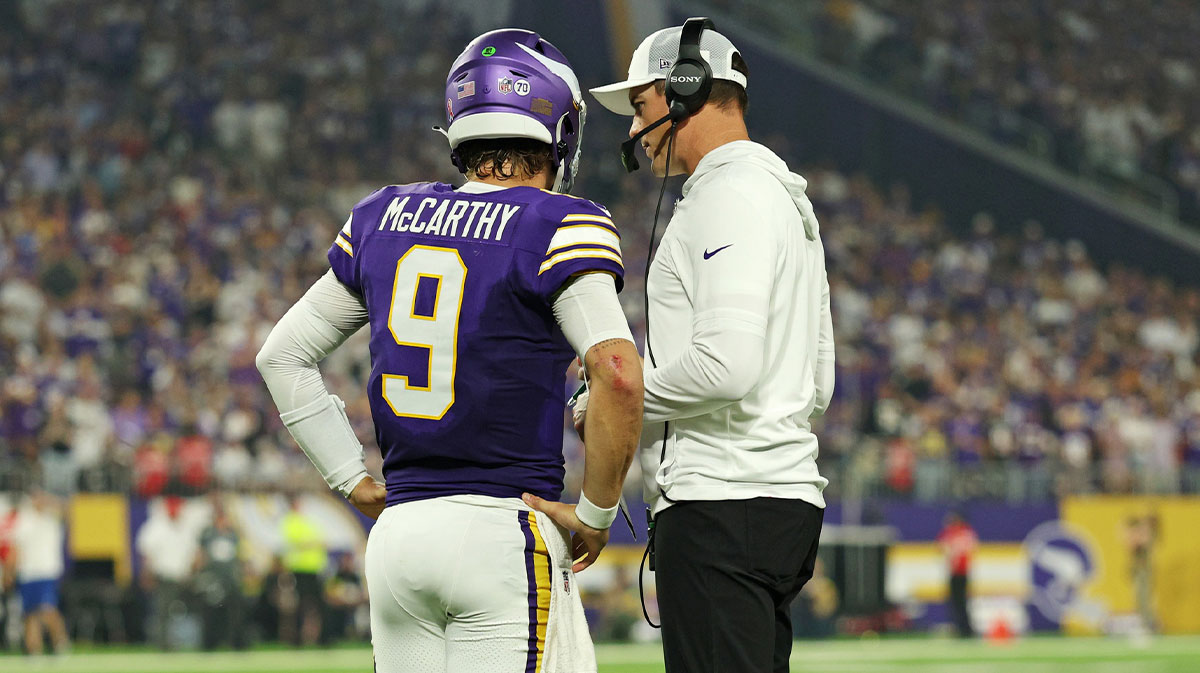 Minnesota Vikings quarterback J.J. McCarthy (9) speaks with Minnesota Vikings head coach Kevin O'Connell during the first half against the Atlanta Falcons at U.S. Bank Stadium.