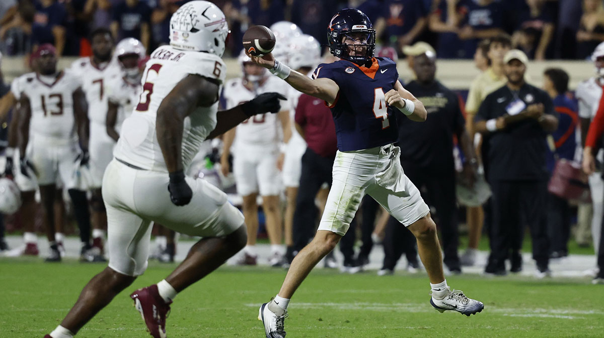 Virginia Cavaliers quarterback Chandler Morris (4) passes the ball as Florida State Seminoles defensive lineman Darrell Jackson Jr. (6) chases in the first overtime period at Scott Stadium.