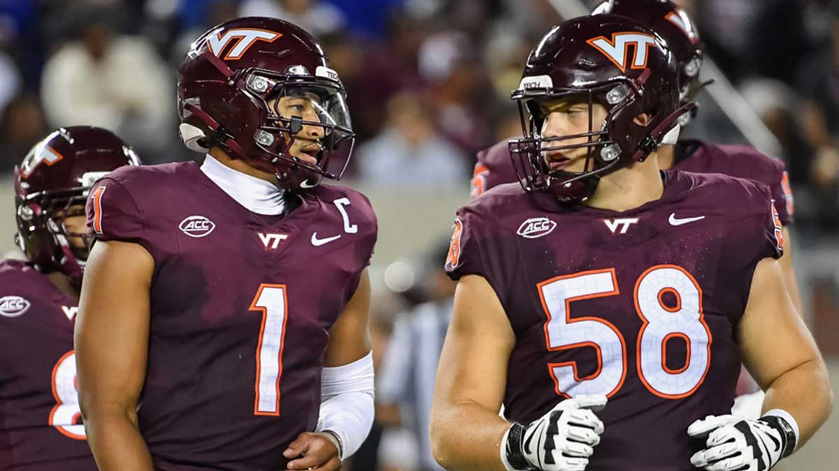 Virginia Tech Hokies quarterback Kyron Drones (1) and Virginia Tech Hokies offensive lineman Tommy Ricard (58) during the second quarter at Lane Stadium