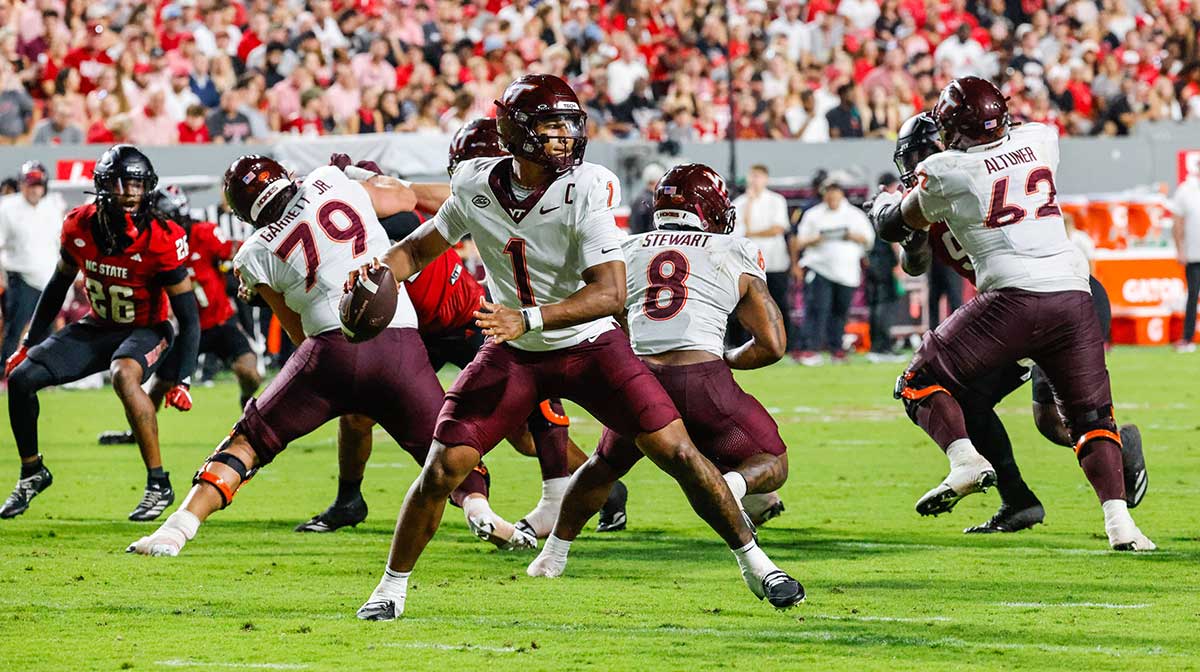 Virginia Tech Hokies quarterback Kyron Drones (1) attempts to throw the ball during the first half of the game against North Carolina State Wolfpack at Carter-Finley Stadium.