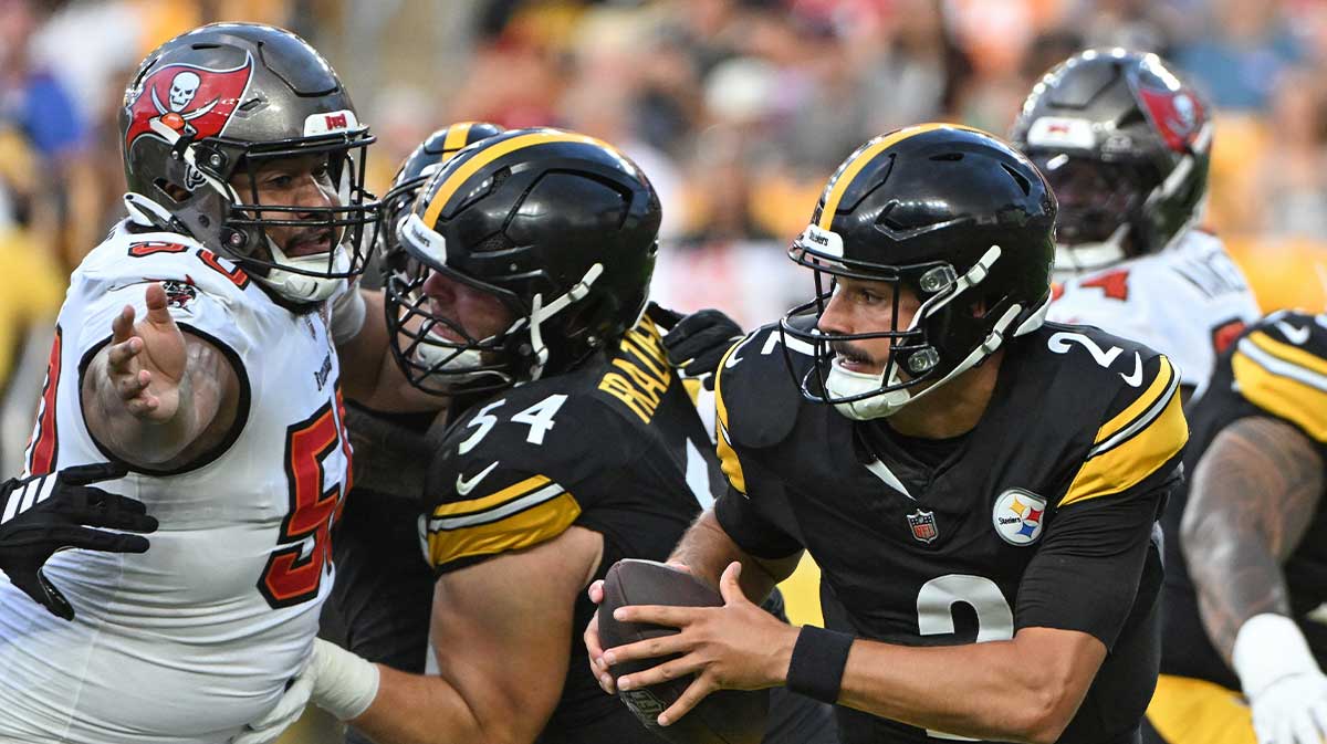 Pittsburgh Steelers quarterback Mason Rudolph (2) scrambles away from Tampa Bay Buccaneers defensive tackle Vita Vea (50) during the first quarter at Acrisure Stadium.