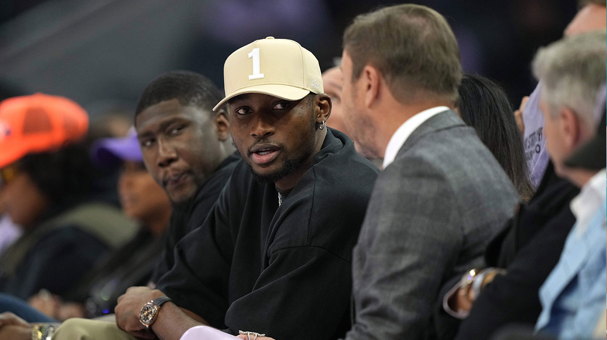 Warriors forward Jonathan Kuminga (center left) talks with owner Joe Lacob (center right) during the second quarter of the game between the Golden State Valkyries and the Los Angeles Sparks at Chase Center