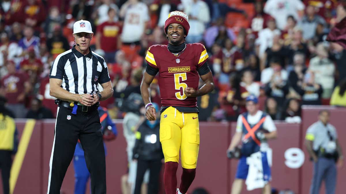 Washington Commanders quarterback Jayden Daniels (5) request the ball after Commanders running back Jacory Croskey-Merritt (not pictured) scores a touchdown against Cincinnati Bengals during the first half at Northwest Stadium.