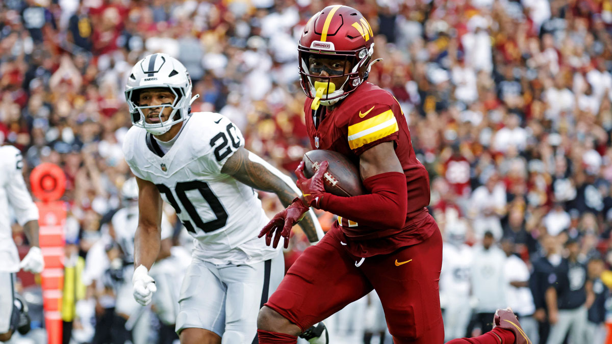 Washington Commanders wide receiver Terry McLaurin (17) runs the ball during the second half as Las Vegas Raiders safety Isaiah Pola-Mao (20) defends at Northwest Stadium.