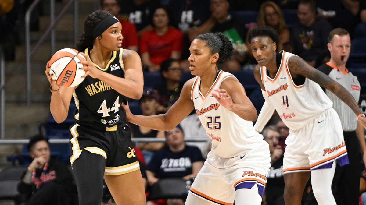 Washington Mystics forward Kiki Iriafen (44) looks to pass in front of Phoenix Mercury forward Alyssa Thomas (25) during the first quarter at CareFirst Arena.