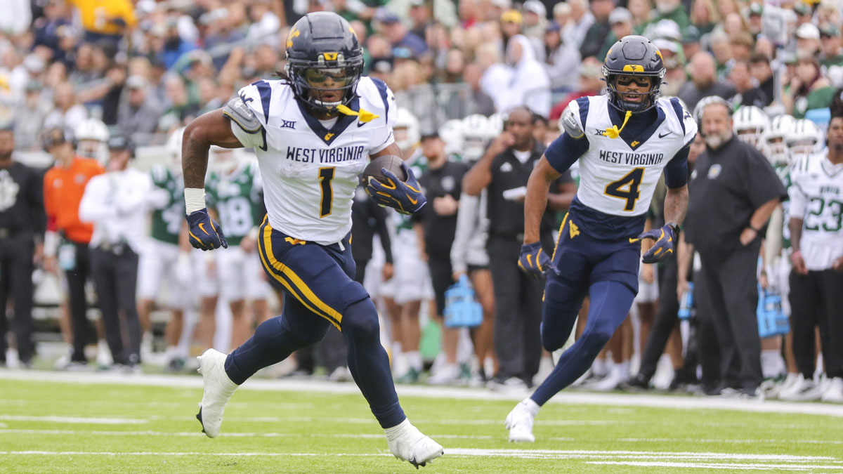West Virginia Mountaineers running back Jahiem White (1) runs the ball for a touchdown during the first quarter against the Ohio Bobcats at Peden Stadium.