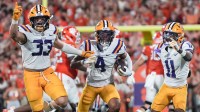 Louisiana State University linebacker West Weeks (33), cornerback Mansoor Delane (4) and cornerback PJ Woodland (11) react playing Clemson during the third quarter at Memorial Stadium in Clemson, S.C. Saturday, August 31, 2025.