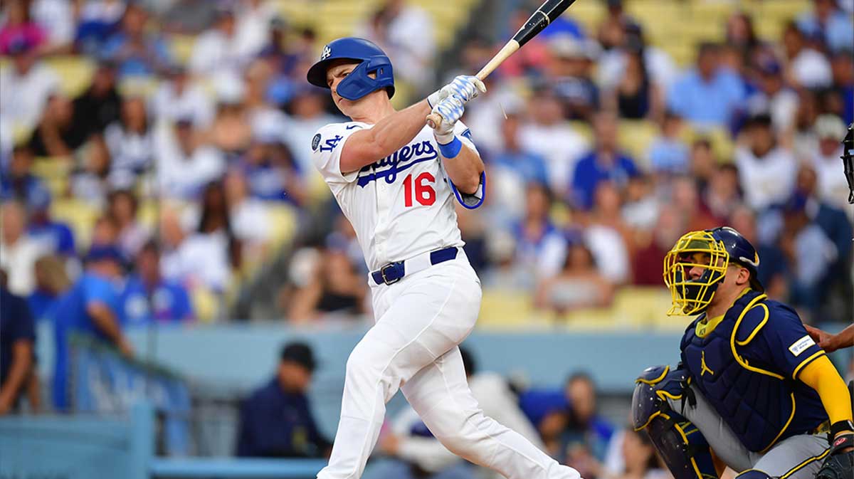 Jul 18, 2025; Los Angeles, California, USA; Los Angeles Dodgers catcher Will Smith (16) hits a single in the second inning against the Milwaukee Brewers at Dodger Stadium.