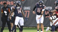 Chicago Bears wide receiver Olamide Zaccheaus (14) celebrates with Chicago Bears quarterback Caleb Williams (18) after scoring a touchdown against the Buffalo Bills during the first half at Soldier Field.