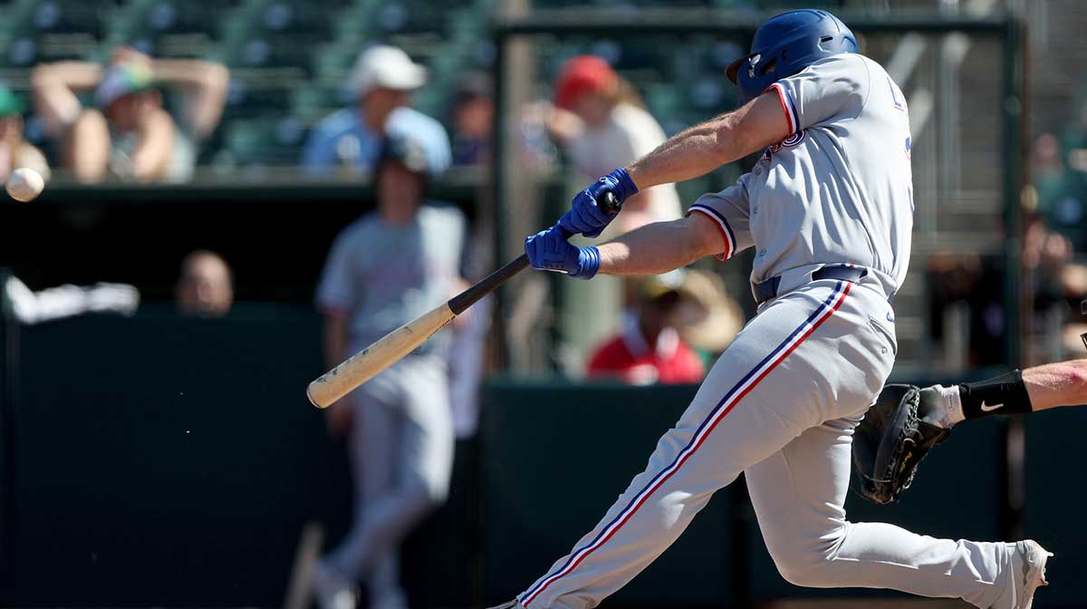 Texas Rangers left fielder Wyatt Langford (36) hits a RBI sacrifice fly against the Athletics during the eighth inning at Sutter Health Park.