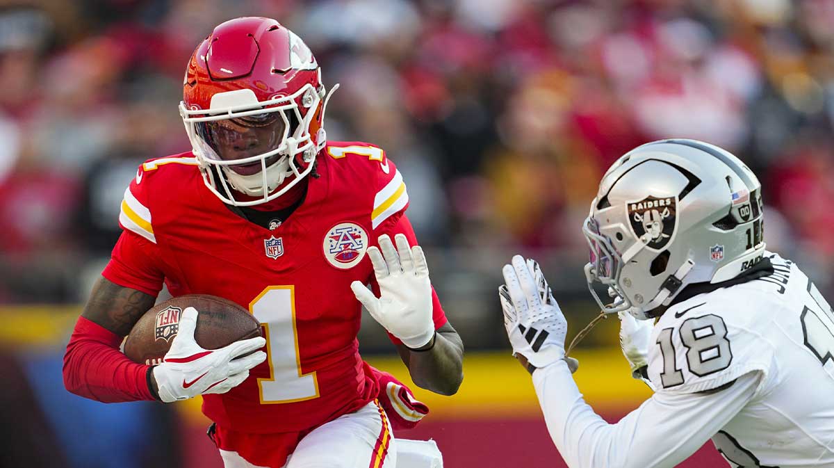 Kansas City Chiefs wide receiver Xavier Worthy (1) runs with the ball against Las Vegas Raiders cornerback Darnay Holmes (30) during the first half at GEHA Field at Arrowhead Stadium. 