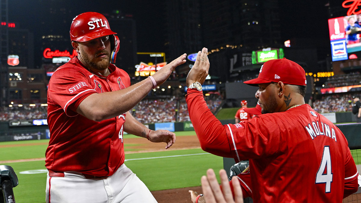 St. Louis Cardinals catcher Pedro Pages (43) is congratulated by guest coach Yadier Molina (4) after scoring against the Chicago Cubs during the fifth inning at Busch Stadium.