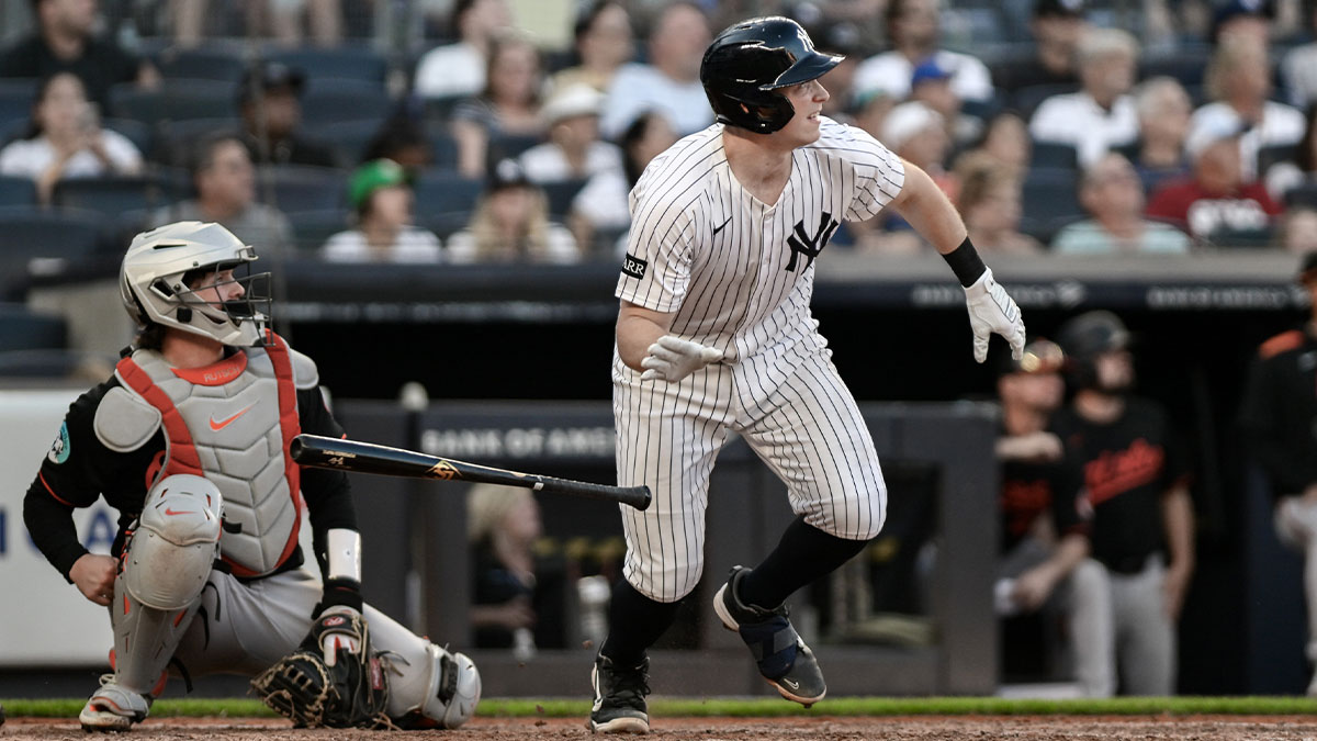 New York Yankees first baseman Ben Rice (22) hits a solo home run against the Baltimore Orioles during the eighth inning at Yankee Stadium.