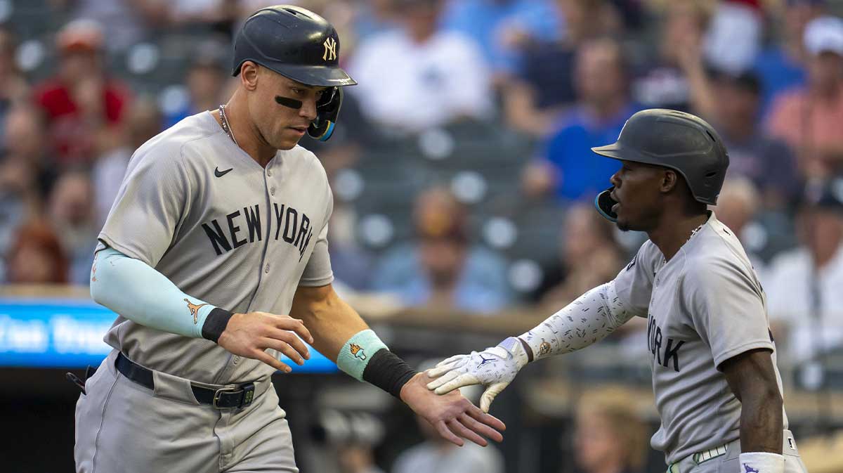 New York Yankees right fielder Aaron Judge (99) shakes hands with second baseman Jazz Chisholm Jr. (13) after scoring a run against the Minnesota Twins in the first inning at Target Field.