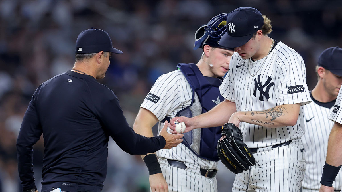 New York Yankees manager Aaron Boone (17) takes the ball from starting pitcher Cam Schlittler (31) during a pitching change during the second inning against the Toronto Blue Jays at Yankee Stadium.
