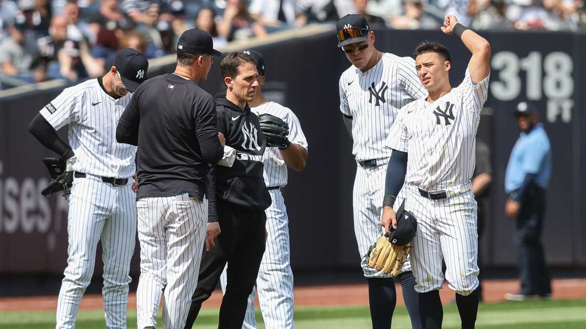 New York Yankees shortstop Anthony Volpe (11) is checked on in the eighth inning against the Tampa Bay Rays at Yankee Stadium.