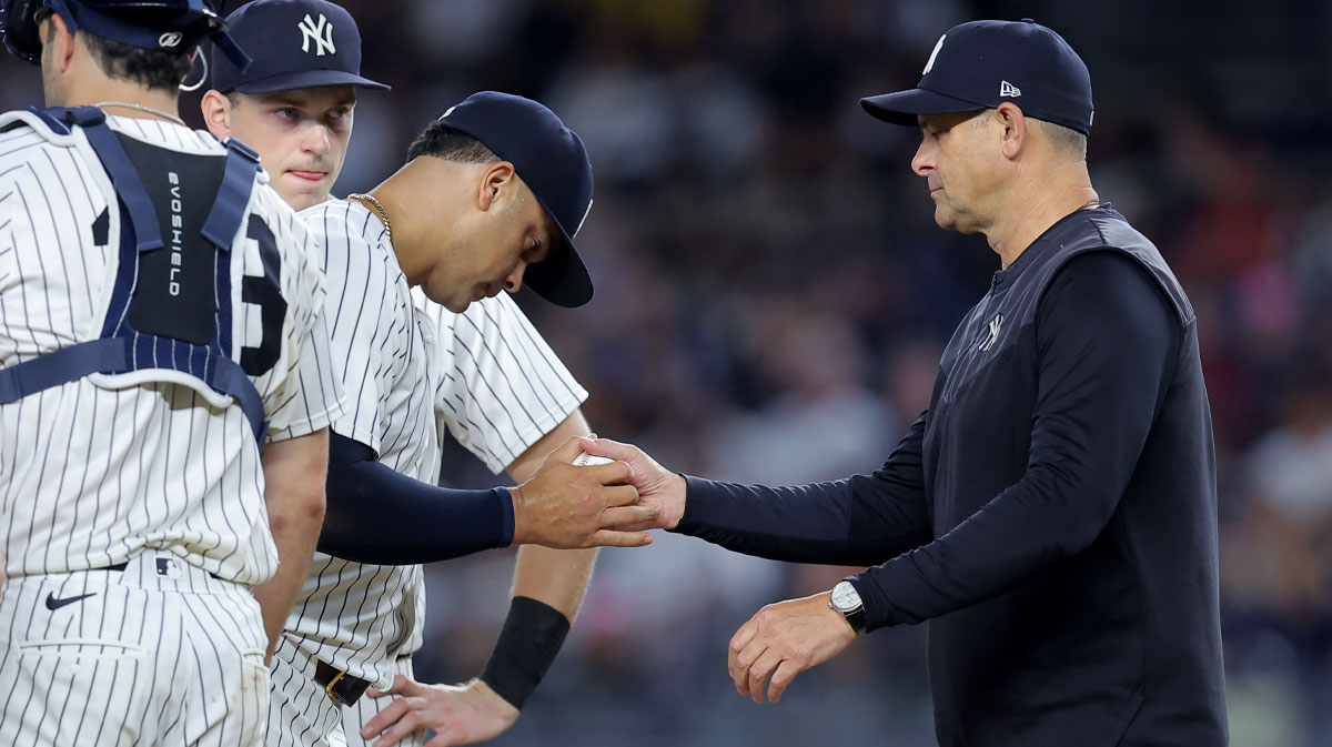 Yankees manager Aaron Boone (17) takes the ball from relief pitcher