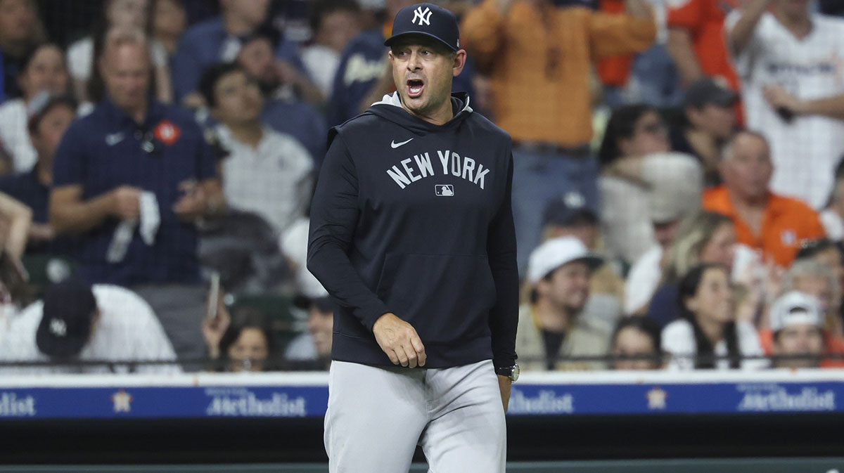 New York Yankees manager Aaron Boone looks towards home plate during a pitching change in the eighth inning against the Houston Astros at Daikin Park.