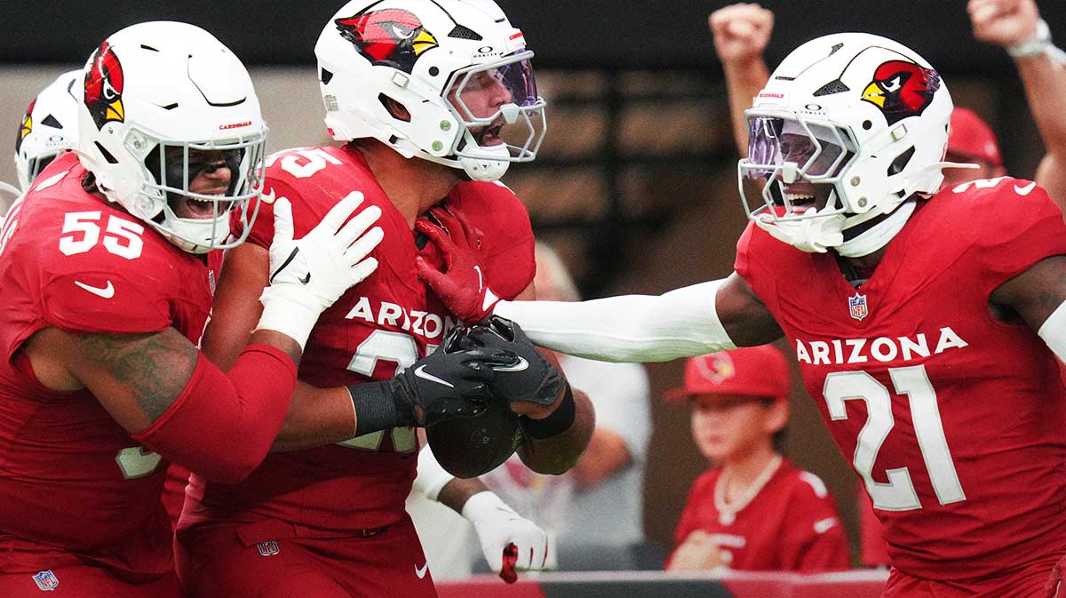 Arizona Cardinals linebacker Zaven Collins (25) celebrates his touchdown on a recovered fumble with teammates Garrett Williams (21) and Dante Stills (55) during their game against the Carolina Panthers.