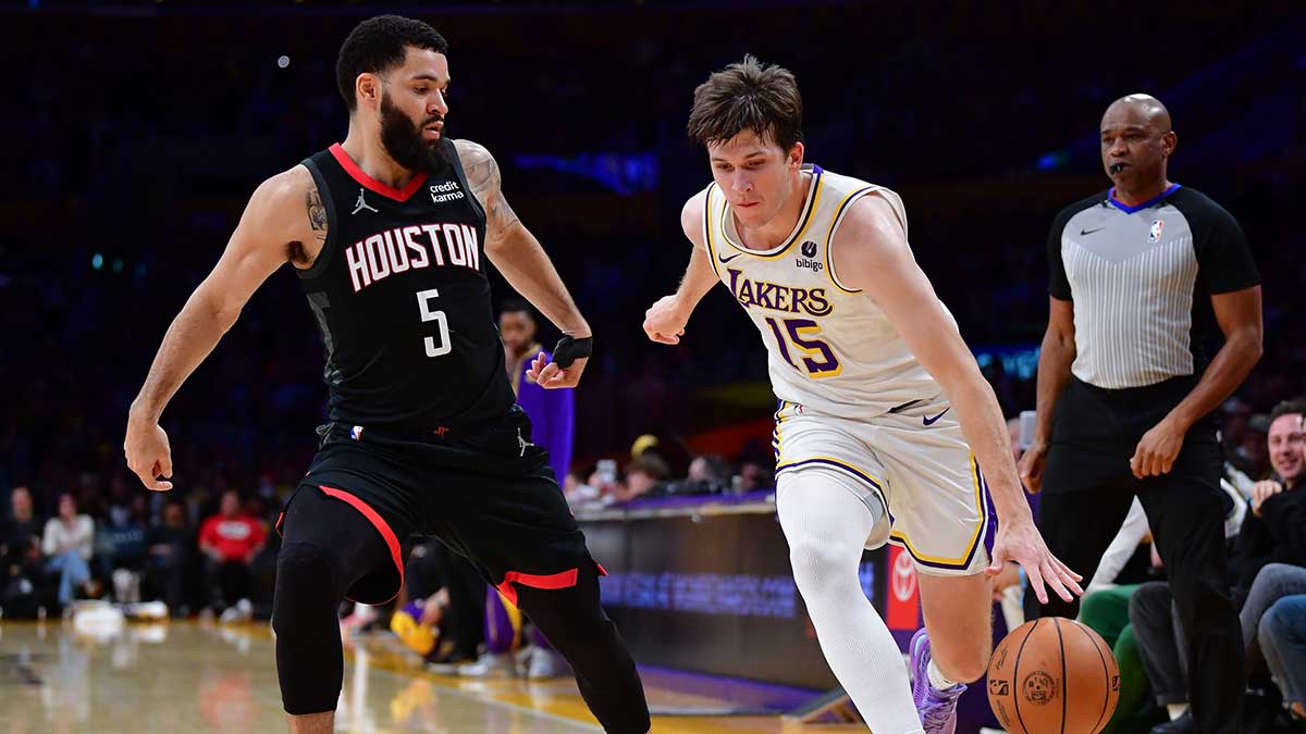 Lakers guard Austin Reaves (15) moves the ball against Houston Rockets guard Fred VanVleet (5) during the first half at Crypto.com Arena with Zach Lowe in the background