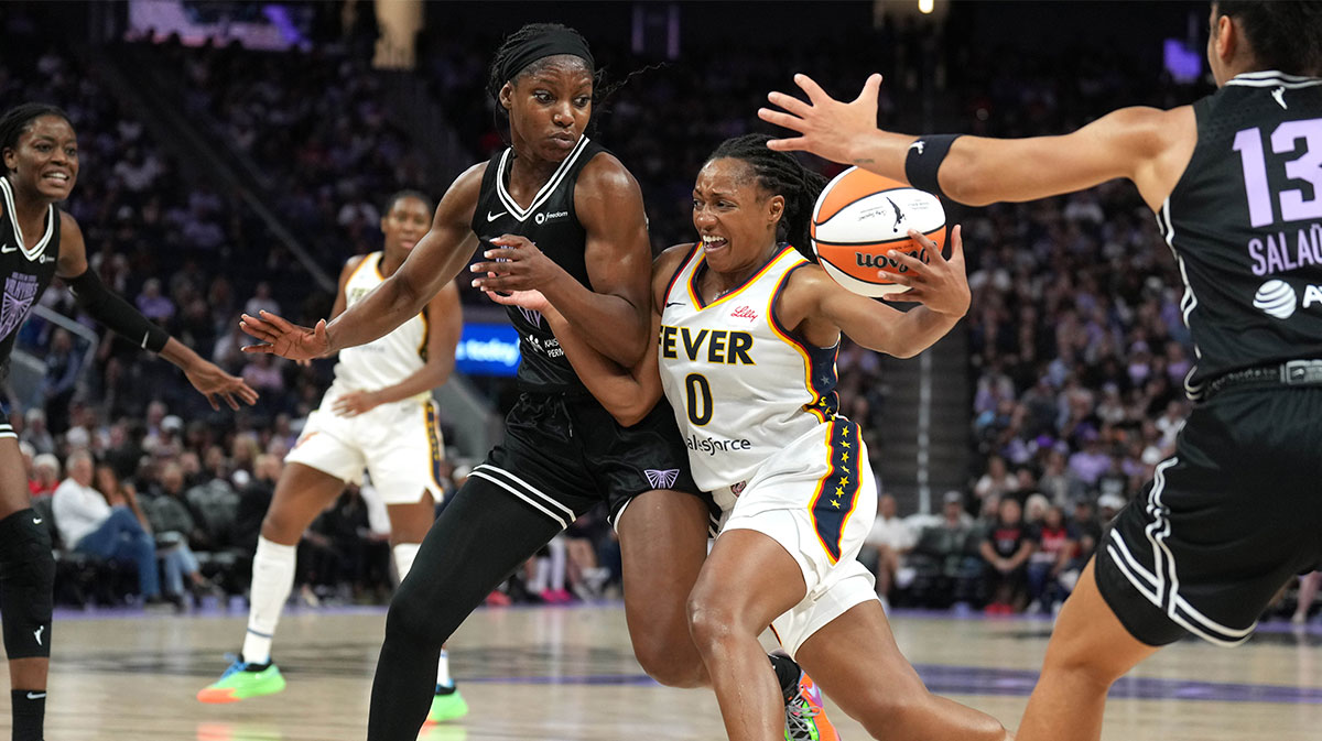 Indiana Fever guard Kelsey Mitchell (0) drives against Golden State Valkyries guard Kaila Charles (center left) and forward Janelle Salaun (13) during the third quarter at Chase Center.