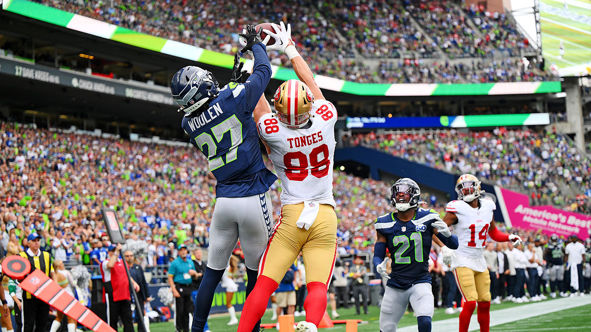 San Francisco 49ers tight end Jake Tonges (88) catches the ball for a touchdown being defended by Seattle Seahawks cornerback Riq Woolen (27) during the second half at Lumen Field.