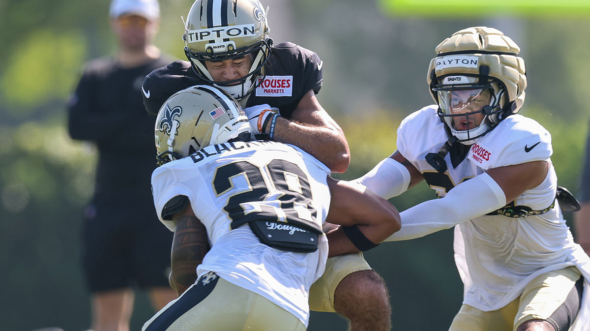 New Orleans Saints wide receiver Mason Tipton (15) is hit on a pass by safety Julian Blackmon (28) at Ochsner Sports Performance Center.