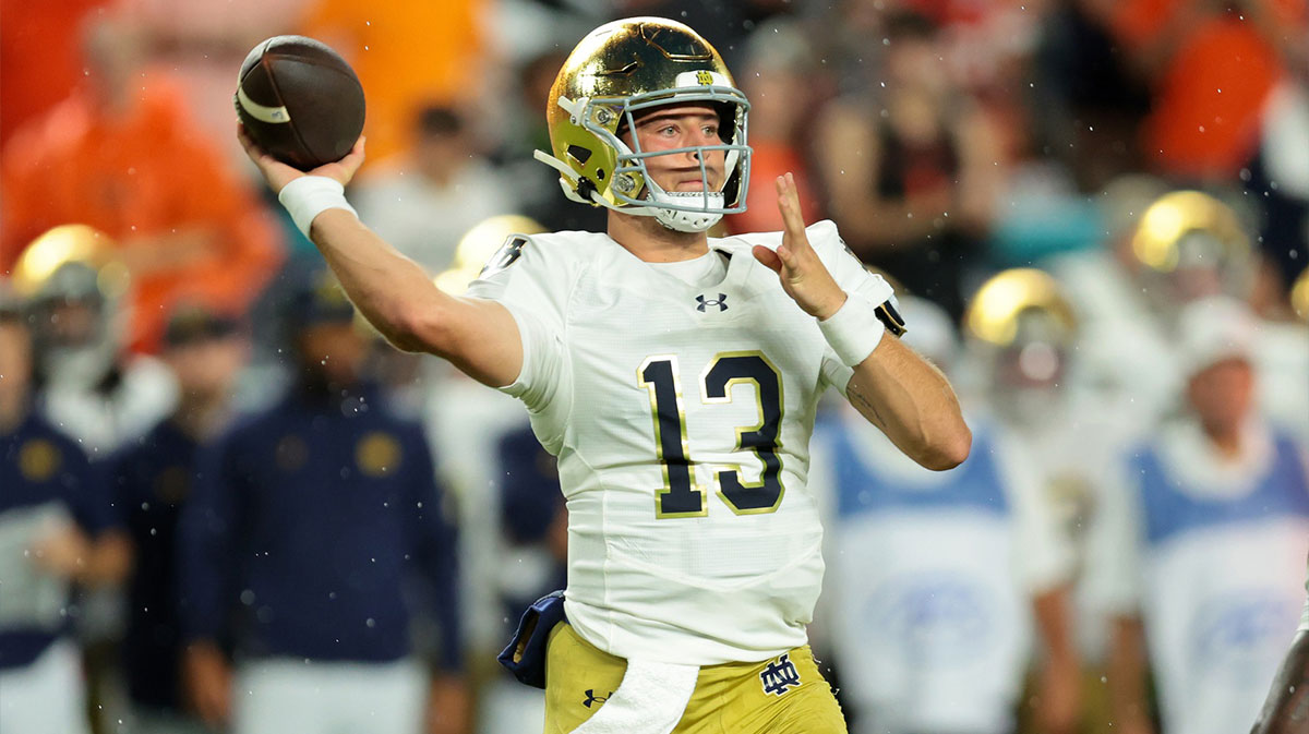 Notre Dame Fighting Irish quarterback CJ Carr (13) drops back to pass against the Miami Hurricanes during the first quarter at Hard Rock Stadium.