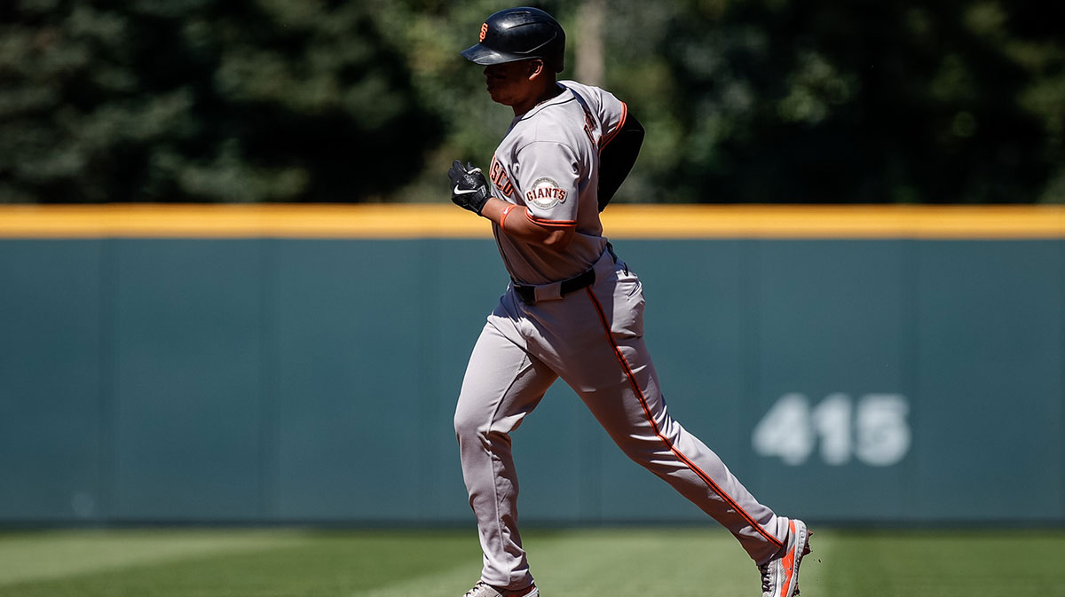; San Francisco Giants designated hitter Rafael Devers (16) rounds the bases on a solo home run in the first inning against the Colorado Rockies at Coors Field.