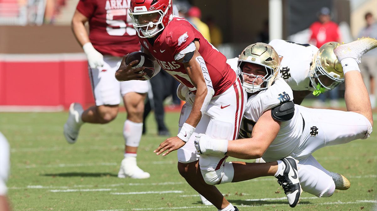 Arkansas Razorbacks quarterback Taylen Green (10) is tackled by Notre Dame Fighting Irish defensive lineman Elijah Hughes (56) during the second half at Donald W. Reynolds Razorback Stadium. Notre Dame won 56-13.